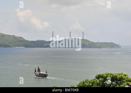 Aqua Luna Tourist Junk sailing south through the East Lamma Channel, against the backdrop of Lamma Island, Hong Kong, China Stock Photo