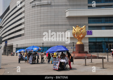The umbrella stalls of three street photographers offering their services to local people, Golden Bauhinia Square, Hong Kong Stock Photo