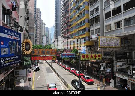 Parked taxis and hoardings along Lockhart Road, looking west from the elevated walkway near O'Brian Road, Wan Chai, Hong Kong Stock Photo