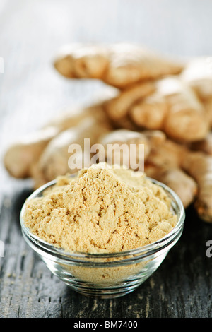 Fresh and ground ginger root spice on wooden table Stock Photo