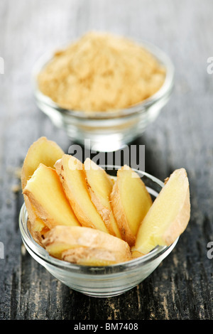 Sliced and ground fresh ginger root spice in glass bowls Stock Photo
