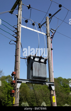 3 Phase electricity transformer mounted between 2 utility poles Upper Arley Village Worcestershire UK Stock Photo