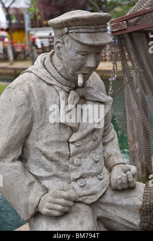 Tulip time festival Dutch Holland Michigan fisherman sculpture  with a cigarette in Nelis' Dutch Village USA US nobody vertical hi-res Stock Photo