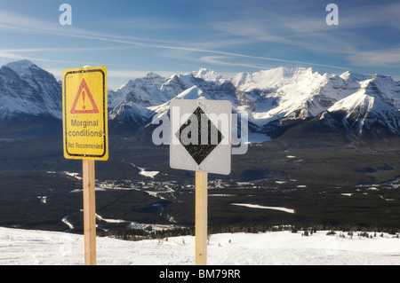 Black diamond and marginal conditions signs at Lake Louise Ske Resort - Banff National Park, Alberta, Canada Stock Photo