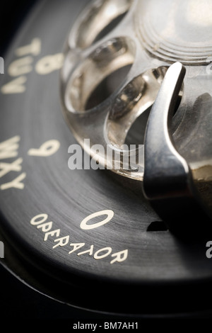 a detail of an old-fashioned rotary phone dial with shallow depth of field and focus on 0 for an operator Stock Photo