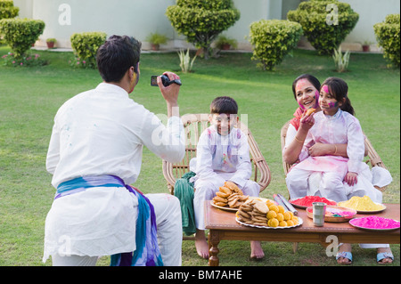 Man filming his family with a video camera on holi Stock Photo