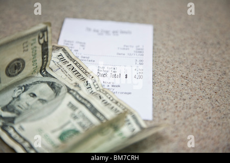 Cash and a receipt on a counter Stock Photo