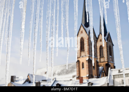 Detail of icicles and a church in the background Stock Photo