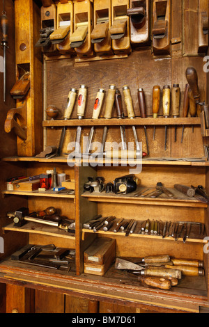 Antique woodworkers cabinet with various tools Stock Photo