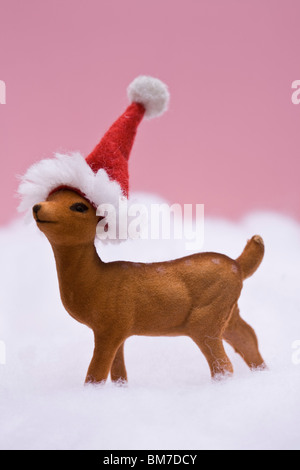 A reindeer figurine standing in fake snow Stock Photo