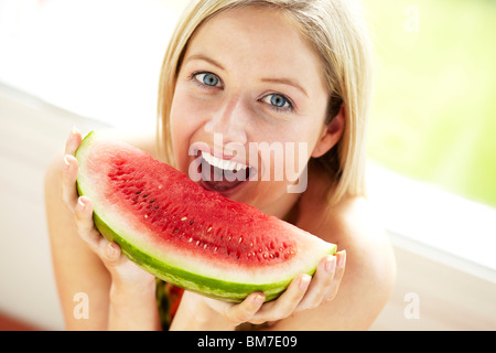 Girl eating Melon Stock Photo