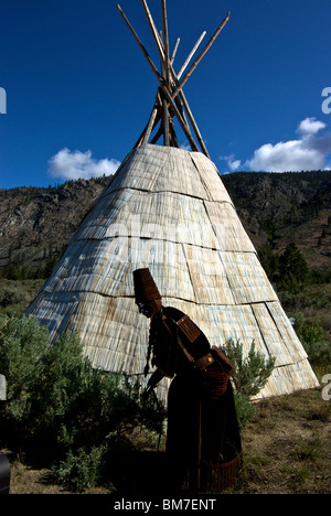 Smoker Marchand outdoor metal sculpture depicting native aboriginal woman and tepee at Nk'Mip Desert Cultural Centre Osoyoos BC Stock Photo