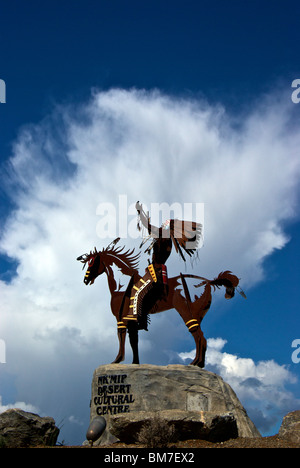 Magnificent Smoker Marchand outdoor metal sculpture of native aboriginal on horseback at entrance Nk'Mip Desert Cultural Centre Stock Photo