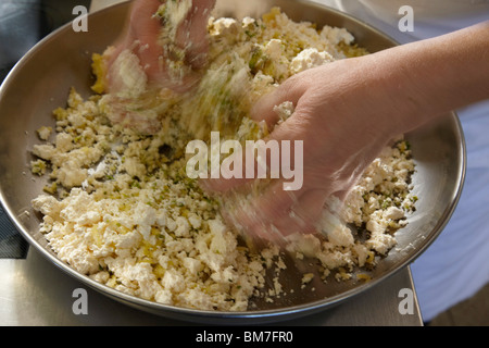 A woman mixing dough with her hands, detail of hands Stock Photo