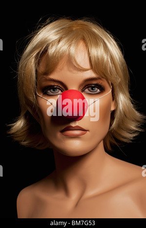 A mannequin wearing a blond wig and a clown's nose Stock Photo