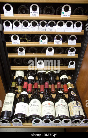 Bottles of Fine Red Wine in Eurocave Storage Cabinet Stock Photo
