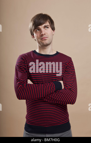 Portrait of a man looking up uncertainly, studio shot Stock Photo