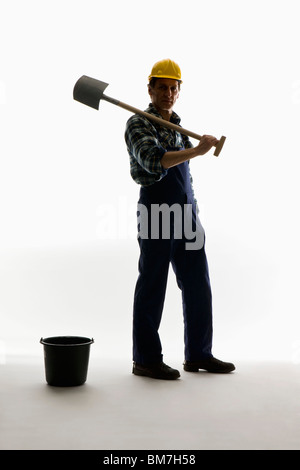 A construction worker posing with a shovel and bucket Stock Photo