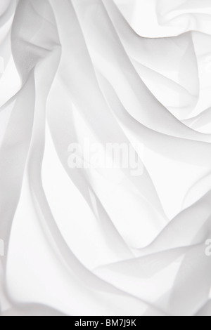 Detail of folded white fabric on a light box Stock Photo