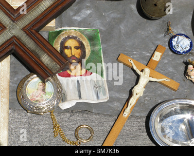 religious objects for sale on market stall in sun Stock Photo