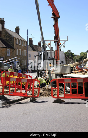 Workmen from the Electricity Company installing new energy efficient street lighting poles in Dorset England Stock Photo