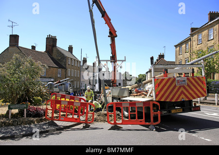 Workmen from the Electricity Company installing new energy efficient street lighting poles in Dorset England Stock Photo