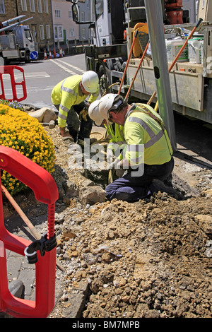 Workmen from the Electricity Company installing new energy efficient street lighting poles in Dorset England Stock Photo