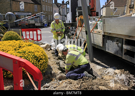 Workmen from the Electricity Company installing new energy efficient street lighting poles in Dorset England Stock Photo