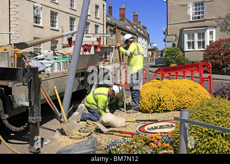 Workmen from the Electricity Company installing new energy efficient street lighting poles in Dorset England Stock Photo