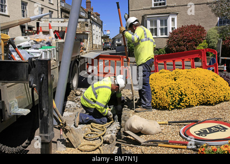 Workmen from the Electricity Company installing new energy efficient street lighting poles in Dorset England Stock Photo