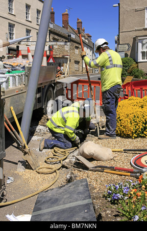 Workmen from the Electricity Company installing new energy efficient street lighting poles in Dorset England Stock Photo