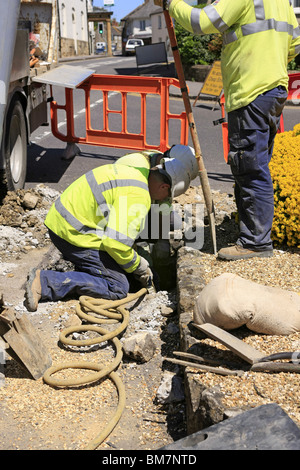 Workmen from the Electricity Company installing new energy efficient street lighting poles in Dorset England Stock Photo