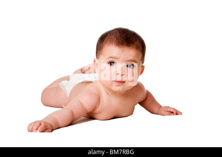Beautiful cute happy Caucasian Hispanic baby infant laying on belly, wearing diaper, isolated. Stock Photo