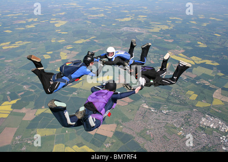 Four skydivers in free fall doing formations Stock Photo