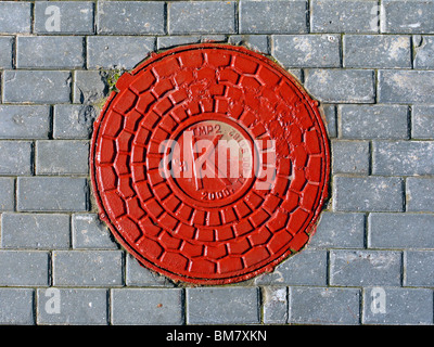 Bright red sewer manhole in Moscow, Russia Stock Photo