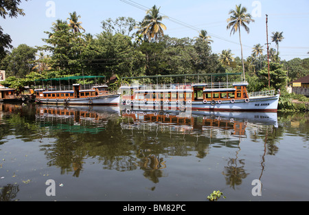 Tourists boats moored in Alappuzha or Alleppey on the backwaters of Kerala in India. Stock Photo