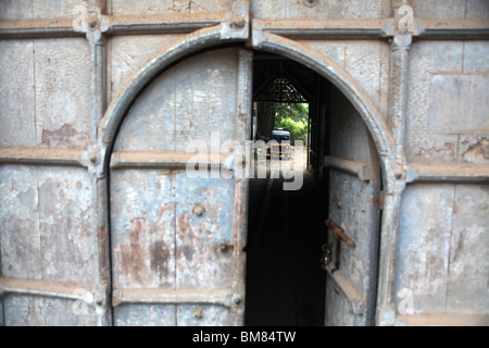 View through an open doorway, showing a tuk tuk in the distance in Jew Town in Kochi, formerly known as Cochin in Kerala, India. Stock Photo