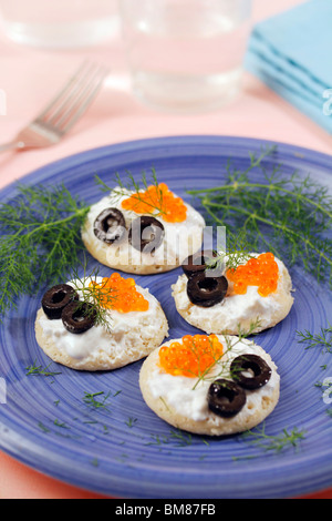 Blinis with trout caviar. Recipe available. Stock Photo