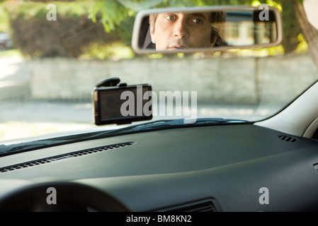 Driver checking rear-view mirror Stock Photo
