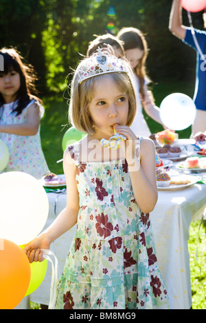 Girl With Blower At Outdoor Birthday Party Stock Photo - Alamy