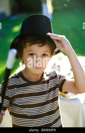 Boy with magic wand and magician's hat, portrait Stock Photo