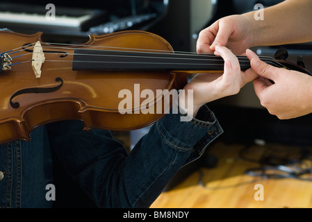 Learning to play the violin Stock Photo