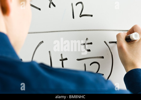 Writing mathematic equation on whiteboard Stock Photo