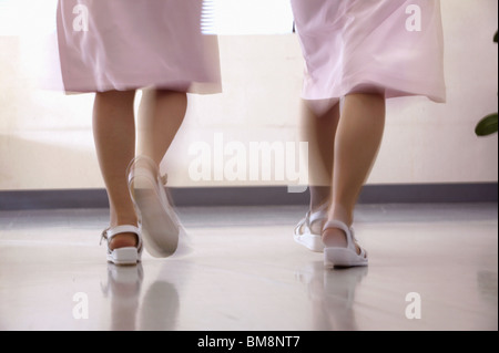 Female nurses walking in corridor quickly, blurred motion Stock Photo