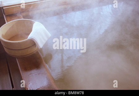 Wooden bucket on bathtub Stock Photo
