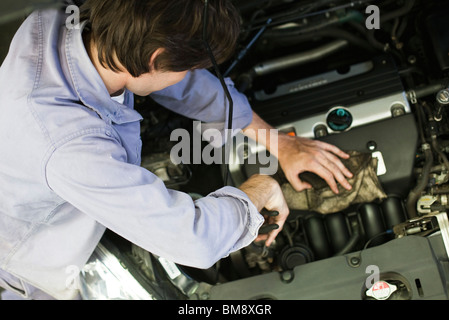 Mechanic repairing car engine Stock Photo