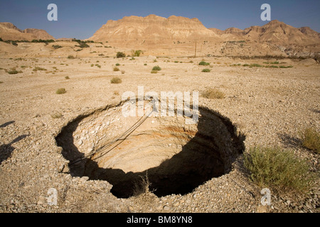 Israel, Dead Sea A sinkhole caused by the receding water level of the Dead Sea Stock Photo