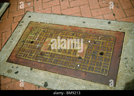 An access port for underground infrastructure is seen on the street in Newark, NJ on Saturday, May 22, 2010. Stock Photo