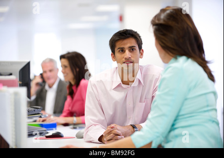 Young Asian Indian male adult at office desk Stock Photo