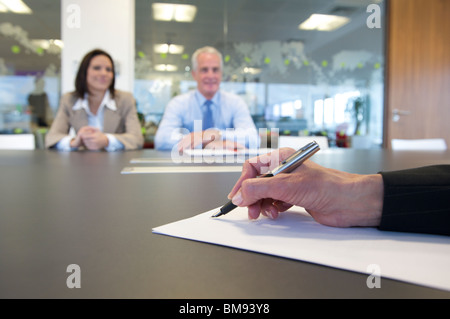 Hand and pen close up in a business meeting Stock Photo